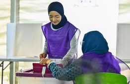 An election official active at the ballot station. -- Photo: Fayaz Moosa / Mihaaru News