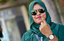 A voter who has cast her ballot showing her left forefinger marked with election ink. -- Photo: Fayaz Moosa / Mihaaru News