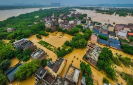 This aerial photograph taken on April 22, 2024 shows flooded buildings and streets after heavy rains in Qingyuan, in southern China's Guangdong province. -- Photo: STR / AFP