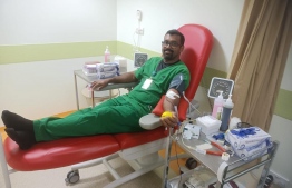 An employee donating blood during the blood donation campaign proceeded by the Tree Top Hospital.