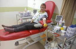 An individual donating blood during the blood donation campaign proceeded by the Tree Top Hospital.