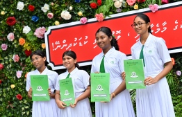Students of Aminiya School standing for a picture after receiving their report books. -- Photo: Nishan Ali / Mihaaru News