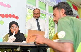 Minister of Homeland Security and Technology, Ali Ihusaan waiting after the inauguration ceremony held in Kaafu atoll Himmafushi under the name "Kurangi" to observe an immigrant checking their fingerprint into the system. -- Photo: Nishan Ali / Mihaaru News