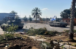 This handout picture released by the Israeli army shows the 401st Brigade's combat team tanks entering the Palestinian side of the Rafah border crossing between Gaza and Egypt in the southern Gaza Strip on May 7, 2024. The Israeli army said it took "operational control" of the Palestinian side of the Rafah border crossing on May 7 and that troops were scanning the area. -- Photo: Israeli Army / AFP