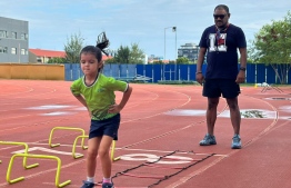 Naseer Ismail coaching a young student at Naseer Sports Academy.