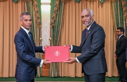 President Dr Mohamed Muizzu presenting Mohamed Luveiz with the letter of appointment into the post of High Commissioner to Singapore. -- Photo: President's Office
