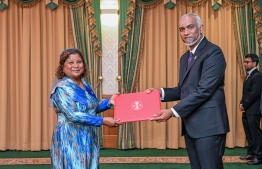 President Dr Mohamed Muizzu presenting Dr Salma Rasheed with the letter of appointment into the post of Permanent Representative to the United Nations Office in Geneva. -- Photo: President's Office