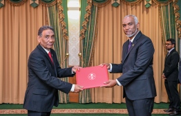 President Dr Mohamed Muizzu presenting Masood Imad with the letter of appointment into the post of High Commissioner to Sri Lanka. -- Photo: President's Office