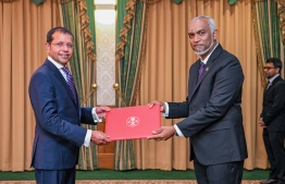 President Dr Mohamed Muizzu presenting Dr Ali Naseer Mohamed with the letter of appointment into the role of Permanent Representative to the United Nations (PMNY). -- Photo: President's Office