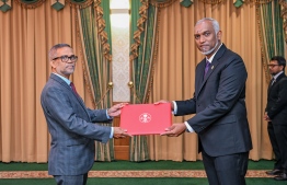 President Dr Mohamed Muizzu presenting Dr Fazeel Najeeb with the letter of appointment into the post of Ambassador to China. -- Photo: President's Office