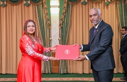 President Dr Mohamed Muizzu presenting Iruthisham Adam with the letter of appointment into the role of High Commissioner to the United Kingdom. -- Photo: President's Office