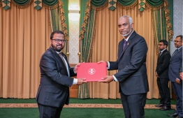 President Dr Mohamed Muizzu presenting Mohamed Hussain Shareef with the letter of appointment into the role of Ambassador to the United Arab Emirates (UAE). -- Photo: President's Office