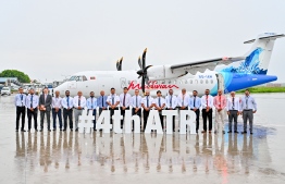 Employees of Maldivian Aero posing for a photo in front of the ATR aircraft brought to Maldives on Wednesday. -- Photo: Nishan Ali / Mihaaru News
