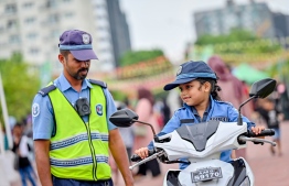 A child participating in an activity hosted by Police officers at the 'Ufaa Festival' held on Friday inside Hulhumale Central Park to commemorate the national Children's Day. -- Photo: Nishan Ali |Mihaaru News