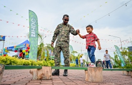 A child participating in an activity hosted by MNDF officers at the 'Ufaa Festival' held on Friday inside Hulhumale Central Park to commemorate the national Children's Day. -- Photo: Nishan Ali |Mihaaru News