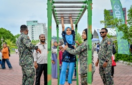 A child participating in an activity hosted by MNDF officers at the 'Ufaa Festival' held on Friday inside Hulhumale Central Park to commemorate the national Children's Day. -- Photo: Nishan Ali |Mihaaru News