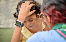 A child getting her face painted at a stall inside the 'Ufaa Festival' held on Friday at Hulhumale Central Park to commemorate the national Children's Day. -- Photo: Nishan Ali |Mihaaru News
