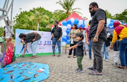 A child participating in an activity featured at a stall during the 'Ufaa Festival' held on Friday inside Hulhumale Central Park to commemorate the national Children's Day. -- Photo: Nishan Ali |Mihaaru News