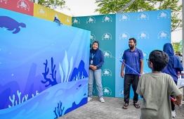 A child participating in an activity featured at the Maldives Transport and Contracting Company (MTCC)'s stall during the 'Ufaa Festival' held on Friday inside Hulhumale Central Park to commemorate the national Children's Day. -- Photo: Nishan Ali |Mihaaru News