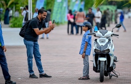 A child posing for a photo in Police uniform during an activity hosted in the Police stall at the 'Ufaa Festival' held on Friday inside Hulhumale Central Park to commemorate the national Children's Day. -- Photo: Nishan Ali |Mihaaru News