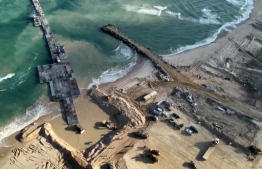 This image grab from a handout video released by the Israeli army on May 18, 2024, shows what the army said is humanitarian aid entering the Gaza Strip via a temporary, floating pier constructed by the United States, amid the ongoing conflict between Israel and the Palestinian militant group Hamas. (Photo by Israeli Army / AFP) / 