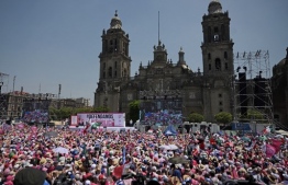 Supporters of opposition presidential candidate Xochitl Galvez, of the Fuerza y Corazon por Mexico coalition party, attend a political rally at Zocalo Square ahead of the national elections in Mexico City on May 19, 2024. (Photo by CARL DE SOUZA / AFP)