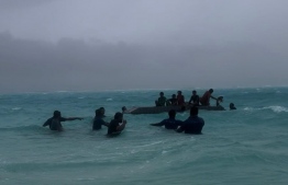 STELCO staff swim in to save children stuck in the sea due to bad weather.