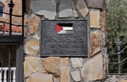 This photograph taken on May 22, 2024 shows a plaque at the entrance of the Palestinian Embassy in Madrid, as the Spanish Prime Minister announced that Spain will recognise Palestine as a state on May 28. "Next Tuesday, May 28, Spain's cabinet will approve the recognition of the Palestinian state," he said, adding that his Israeli counterpart Benjamin Netanyahu was putting the two state solution in "danger" with his policy of "pain and destruction" in the Gaza Strip. -- Photo: Thomas Coex / AFP