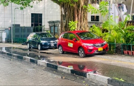 Vehicles parked unlawfully on the pavement next to Sultan Park today. -- Photo: Nishan Ali / Mihaaru News