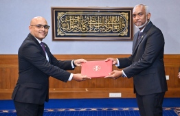President Dr Mohamed Muizzu presents the letter of appointment to Hassan Zaeer -- Photo: President's Office