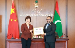 Foreign Minister Moosa Zameer (R) and China Ambassador to the Maldives Wang Lixin (R) at the ceremony held to hand over the donation of mineral water.-- Photo: Foreign Ministry