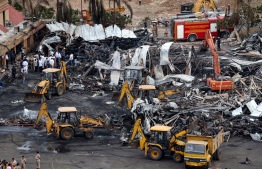 Officials clear charred remains at the site of a fire accident on the following day of the disaster, at an amusement park facility in Rajkot, in India's Gujarat state on May 26, 2024. The death toll from a fire that broke out at a packed amusement and entertainment venue in western India has risen to 27, including four children under the age of 12, local reports said on May 26. -- Photo: AFP