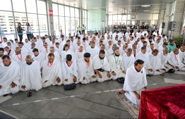 Pilgrims of the first Maldivian Hajj group performing the Friday prayer in congregation at the Velana International Airport (VIA) on Friday before their departure to Saudi Arabia for Hajj. -- Photo: Nishan Ali / Mihaaru News