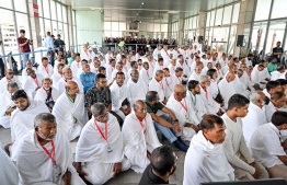 Pilgrims of the first Maldivian Hajj group performing the Dhuhr (midday) prayer in congregation at the Velana International Airport (VIA) on Friday before their departure to Saudi Arabia for Hajj. -- Photo: Nishan Ali / Mihaaru News