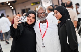 A family of a pilgrim of the first Maldivian Hajj group taking a picture at the Velana International Airport (VIA) on Friday before the pilgrim's departure to Saudi Arabia for Hajj. -- Photo: Nishan Ali / Mihaaru News
