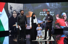 PSM Managing Director Zeena Zahir with the child from the family who donated MVR 50,000 during the telethon -- Photo: PSM