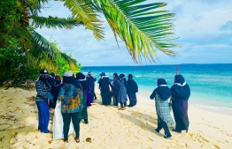 Female natives of Noonu atoll Fodhdhoo cleaning up their beach. -- Photo: Fodhdhoo Council