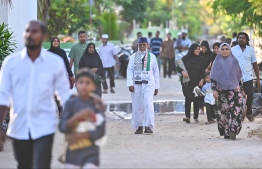 People heading to the B. Kendhoo football stadium to join the Eid-al-Adha prayer congregation today. -- Photo: Fayaz Moosa / Mihaaru News