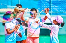 A child blowing bubbles at the Bubble Show held for children in Baa Kendhoo Volleyball Court. -- Photo: Fayaz Moosa / Mihaaru News