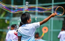 A child blowing bubbles at the Bubble Show held for children in Baa Kendhoo Volleyball Court to colorfully celebrate Eid-al-Adha festivities. -- Photo: Fayaz Moosa / Mihaaru News