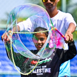 A child blowing bubbles at the Bubble Show held for children in Baa Kendhoo Volleyball Court to colorfully celebrate Eid-al-Adha festivities. -- Photo: Fayaz Moosa / Mihaaru News