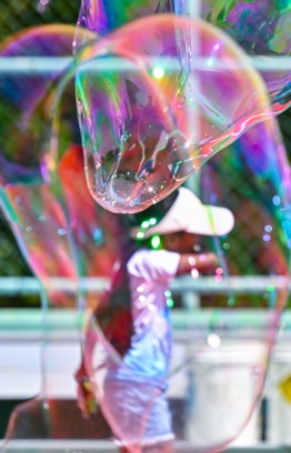 A child inside a large bubble blown at the Bubble Show held for children in Baa Kendhoo Volleyball Court to colorfully celebrate Eid-al-Adha festivities. -- Photo: Fayaz Moosa / Mihaaru News