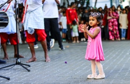 A child clapping for the traditional Boduberu performance hosted on occasion of Eid-al-Adha on the streets yesterday during the vehicle ban from 16:00 hrs to 18:00 hrs. -- Photo: Mihaaru News