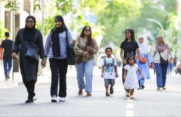 Parents walking on the streets of Male' City yesterday with their children during the vehicle ban issued from 16:00 hrs to 18:00 hrs on occasion of Eid-al-Adha. -- Photo: Mihaaru News