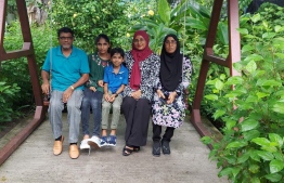 Lucky winner of Dhiraagu 'Win a Tesla' promotion, Musthafa Ahmed with his family.