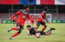 TC Sports Club players attempting to shoot past Super United Sports players with the ball during the U19 Youth Championships 2024 finals. -- Photo: Fayaz Moosa / Mihaaru News