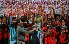 Minister of Sports, Fitness and Recreation, Abdulla Rafiu awarding the cup of the U19 Youth Championships 2024 to the champions of the tournament, TC Sports Club. -- Photo: Fayaz Moosa / Mihaaru News