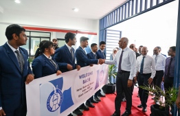 Students of Centre for Higher Secondary Education (CHSE) welcoming President Dr Mohamed Muizzu upon his arrival at the special assembly held at Centre for Higher Secondary Education (CHSE) to commemorate their 45th anniversary with a banner featuring the President's graduation batch/year from the school as well as his school index. -- Photo: President's Office