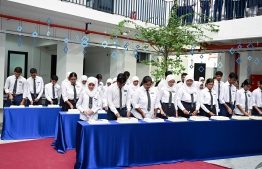 Students of Centre for Higher Secondary Education (CHSE) cutting anniversary cakes at the special assembly held at the school to commemorate their 45th anniversary. -- Photo: President's Office