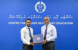 President Dr Mohamed Muizzu receiving a plague of memorandum on his arrival at the Higher Secondary Education (CHSE) to attend the special assembly held at the school to commemorate their 45th anniversary. -- Photo: President's Office